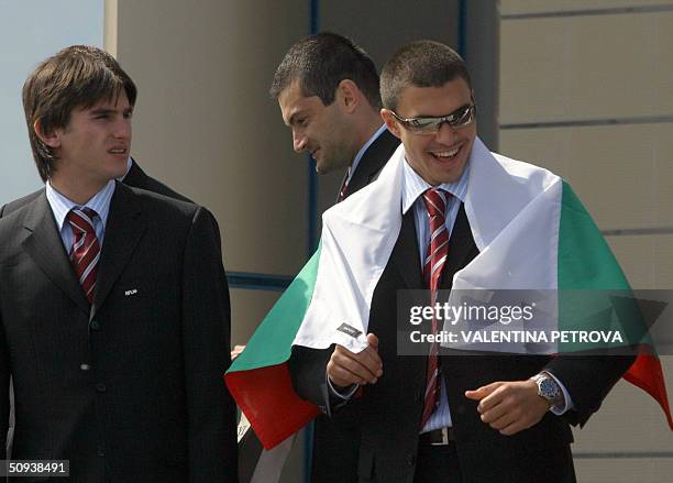 Valeri Bojinov from the Bulgarian national football team wears the Bulgarian national flag as he and his team mates Velizar Dimitrov Stoyan Kolev...