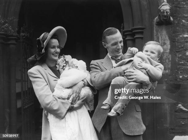 British stage and screen actress Judy Campbell with her husband Lieutenant Commander David Birkin at the christening of their baby daughter, the...