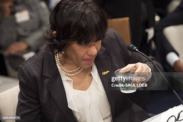 Mayor Karen Weaver of Flint, Michigan, drinks water as she testifies about the lead levels found in Flint's water supply during a House Democratic...