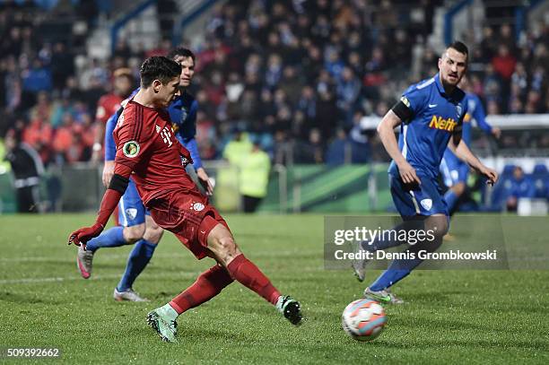 Robert Lewandowski of Bayern Muenchen scores his side's first goal during the DFB Cup quarter final match between VfL Bochum and Bayern Muenchen at...