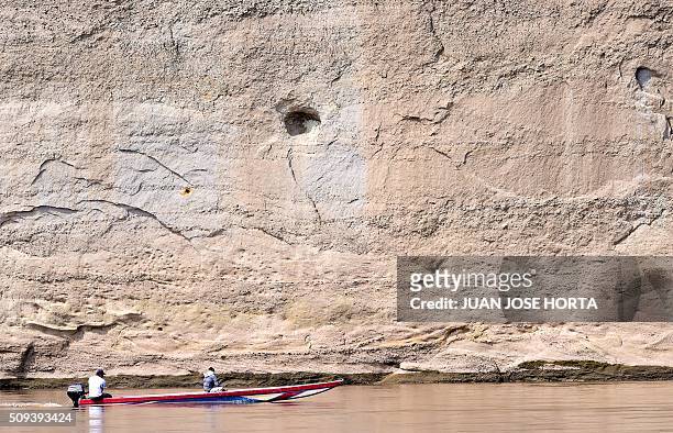 Fisherman sails on his canoe the Magdalena river in La Dorada, Caldas department, Colombia on February 8, 2016. Affected by El Nino, the Magdalena,...