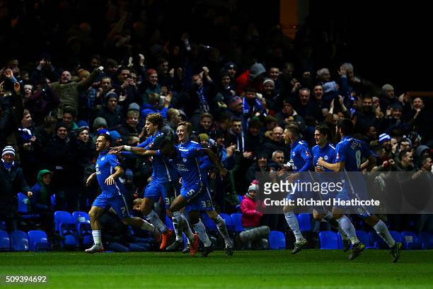 Jon Taylor of Peterborough celebrates with team-mates after scoring the opening goal during the Emirates FA Cup fourth round replay match between...