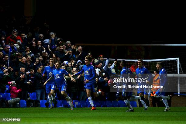 Jon Taylor of Peterborough celebrates with team-mates after scoring the opening goal during the Emirates FA Cup fourth round replay match between...