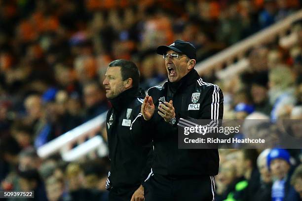 Tony Pulis, manager of West Bromwich Albion encourages his players from the touchline during the Emirates FA Cup fourth round replay match between...