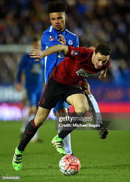 James Chester of West Bromwich Albion shields the ball from Lee Angol of Peterborough during the Emirates FA Cup fourth round replay match between...