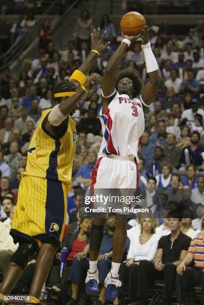 Ben Wallace of the Detroit Pistons shoots over Jermaine O'Neal of the Indiana Pacers in Game six of the Eastern Conference Finals during the 2004 NBA...