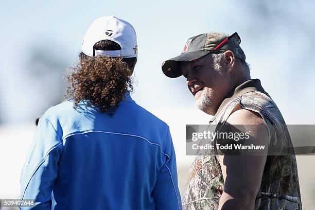 Comedian Daniel Lawrence Whitney , also known as 'Larry the Cable Guy', talks to musician Kenny G after teeing off on the 1st hole during the 3M...