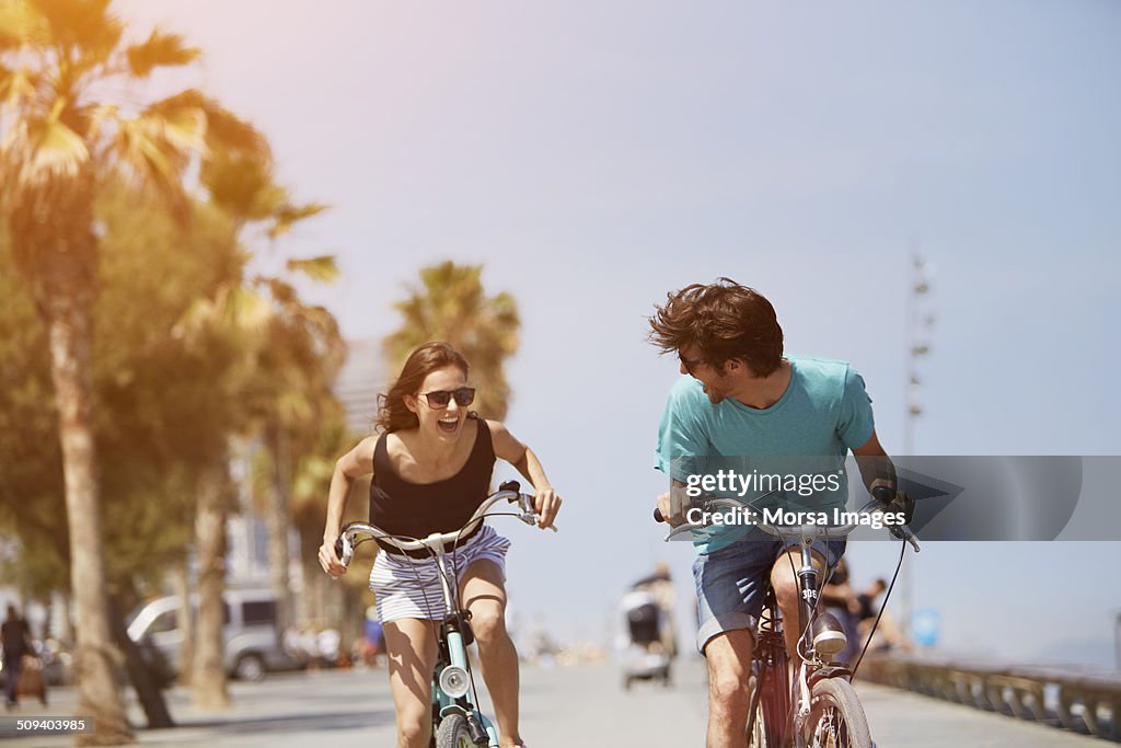 Woman chasing man while riding bicycle