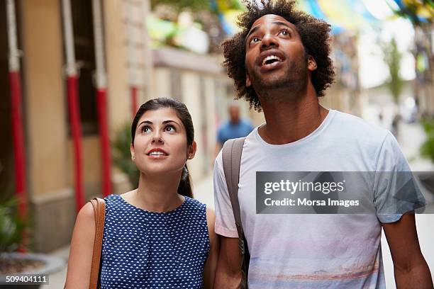surprised couple looking up - surprise stock pictures, royalty-free photos & images
