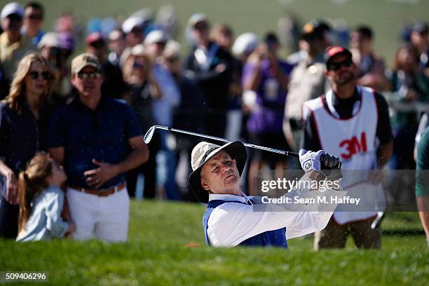 Comedian Bill Murray chips out of a bunker on the second hole during the 3M Celebrity Challenge prior to the AT&T Pebble Beach National Pro-Am at...