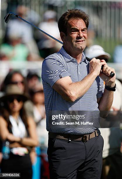 Musician Huey Lewis reacts to his drive off the 17th hole during the 3M Celebrity Challenge prior to the AT&T Pebble Beach National Pro-Am at Pebble...