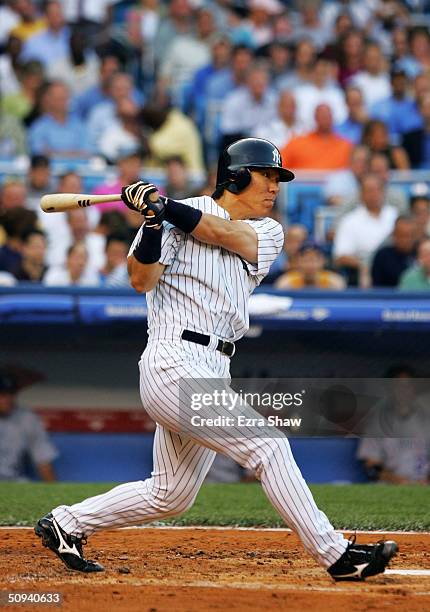 Hideki Matsui of the New York Yankees hits a single in the third inning against the Colorado Rockies on June 8, 2004 at Yankee Stadium in the Bronx,...