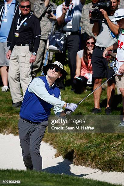 Comedian Bill Murray chips out of a bunker on the first hole during the 3M Celebrity Challenge prior to the AT&T Pebble Beach National Pro-Am at...