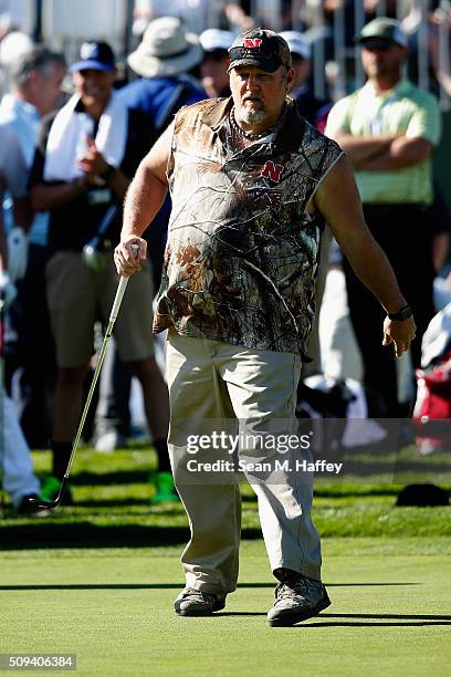 Comedian Daniel Lawrence Whitney, also known as 'Larry the Cable Guy' reacts to a chip shot on the 18th hole during the 3M Celebrity Challenge prior...