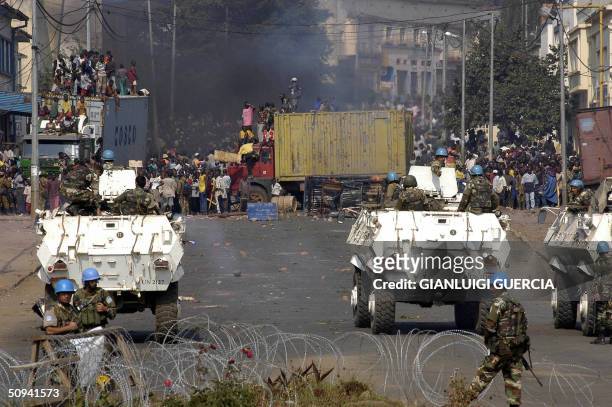 Several thousands Congolese residents of Bukavu gather 09 June 2004 in front of a MONUC roadblock to demonstrate against the UN and cheer the return...