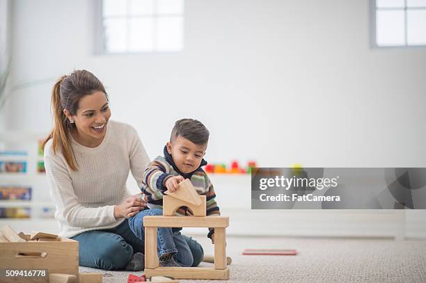 building a block tower - indian mother stock pictures, royalty-free photos & images