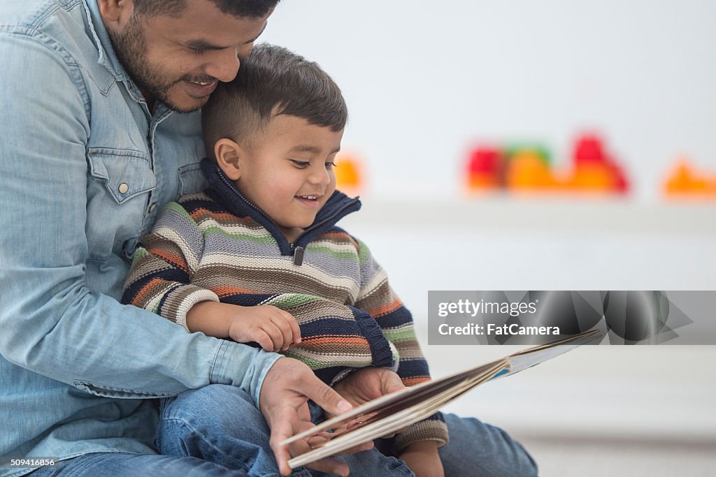 Father Reading His Son a Book