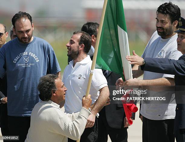 Umberto Cupertino , who is greeted by his father , Salvatore Stefio and Maurizio Agliana, the three Italian hostages freed yesterday by coalition...