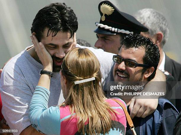 Former hostage Maurizio Agliana is greeted by his sister Antonella, as the three Italian hostages freed yesterday by coalition forces in Iraq, arrive...
