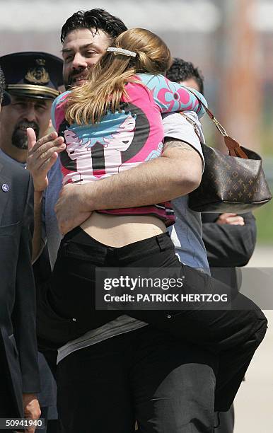 Maurizio Agliana is greeted by his sister Antonella, as the three Italian hostages freed yesterday by coalition forces in Iraq, arrive at Rome's...