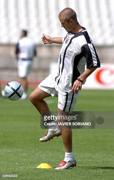 England's David Beckham in action during a training session with his team at 'Primero de Maio' stadium in Braga in preparation for the European 2004...