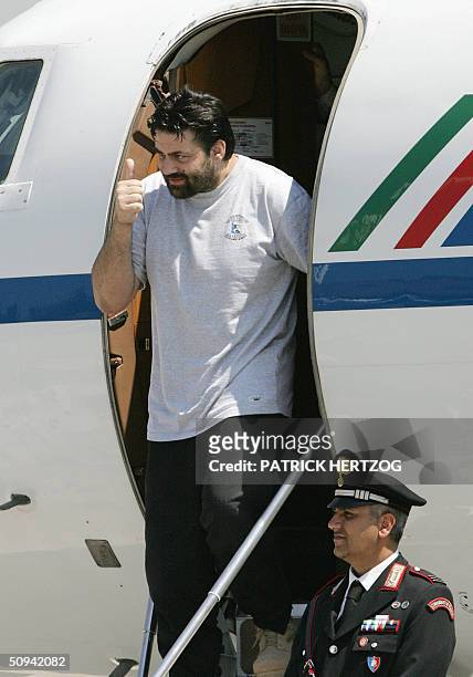 Former Italian hostage Maurizio Agliana gestures 09 June 2004 as he arrives at Rome's Ciampino airport with two other Italian hostages freed 08 June...