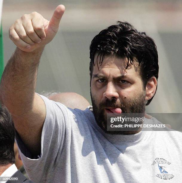 Former Italian hostage Maurizio Agliana gestures 09 June 2004 as he arrives at Rome's Ciampino airport with two other Italian hostages freed 08 June...