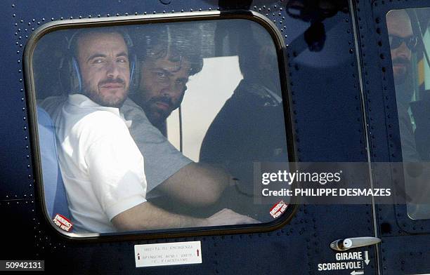 Former Italian hostages Umberto Cupertino and Maurizio Agliana sit in a helicopter 09 June 2004 after arriving at Rome's Ciampino airport with...