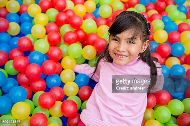 girl playing at the ball pool - adult ball pit stock pictures, royalty-free photos & images