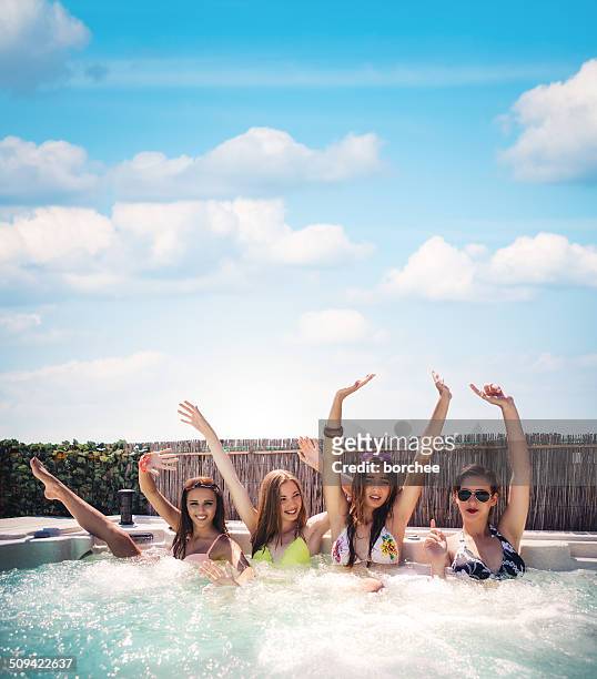 friends having fun in hot tub - girls in hot tub stockfoto's en -beelden