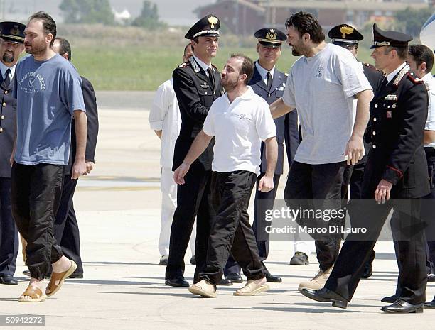 Italian hostages Salvatore Stefio , Umberto Cupertino and Maurizio Agliana arrive at Ciampino Military airbase on June 9, 2004 in Rome, Italy. The...