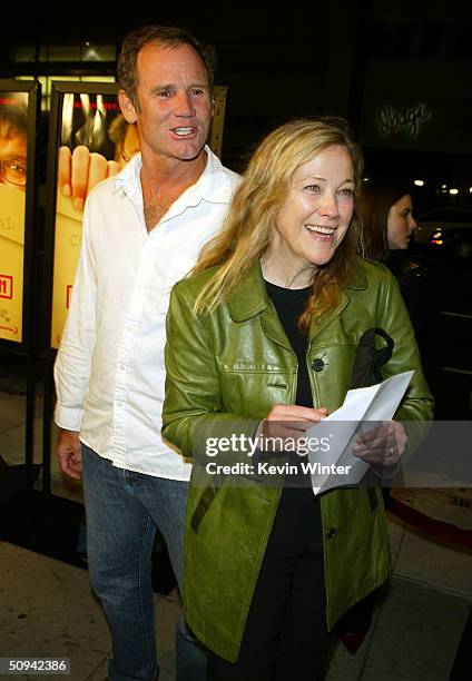 Actress Catherine O'Hara and her husband Bo arrive at a screening of Michael Moore's "Fahrenheit 9/11" on June 8, 2004 in Beverly Hills, California.