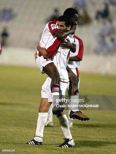 Emirati Ismail Matar celebrates with his temamate Rashid Abdullah after scoring a goal during their 2006 World Cup Asian zone qualifying match againt...