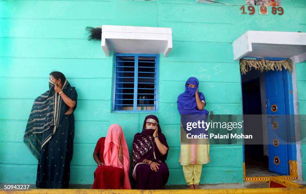 In this particular community northeast of the state capital Hyderabad, sex workers wait for customers April 16, 2004 in the Indian state of Andhra...