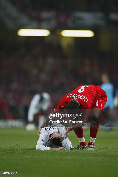 Franck Queudrue of Middlesbrough helps Nicky Hunt of Bolton Wanderers back to his feet during the Carling Cup Final match between Bolton Wanderers...