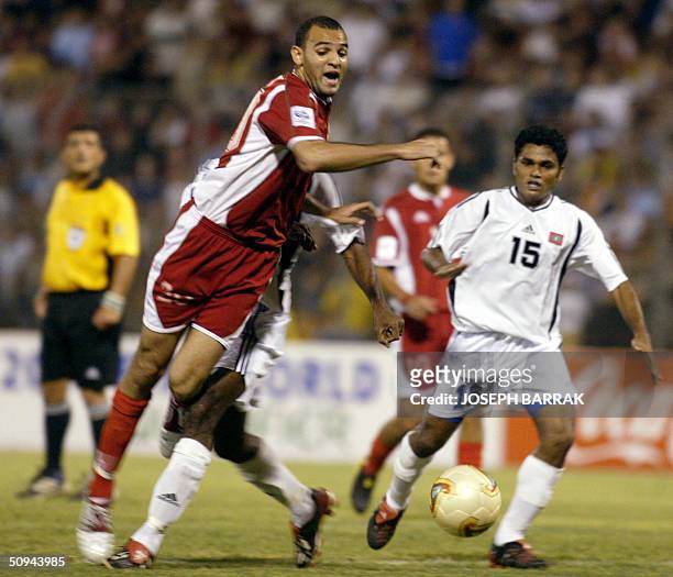 Lebanon's Roda Antar is tackled by Luthfy Ashraf of Maldives during their 2006 World Cup Asian zone qualifying match in Beirut 09 June 2004. AFP...