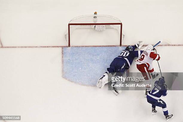 Goalie Ben Bishop of the Tampa Bay Lightning stretches to make a save against Joakim Andersson of the Detroit Red Wings during the third period at...