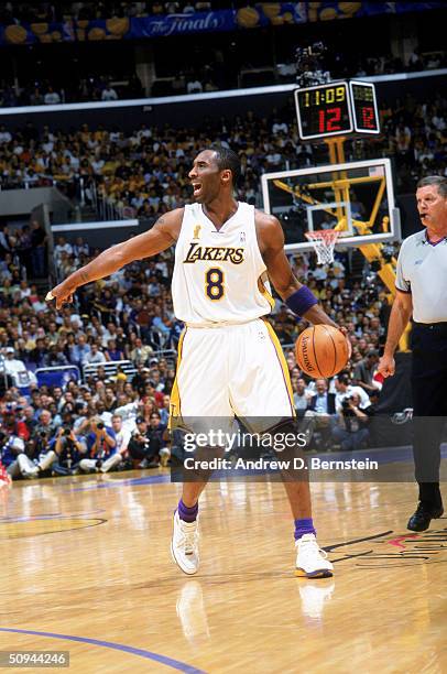 Kobe Bryant of the Los Angeles Lakers points as he handles the ball during Game One of the 2004 NBA Finals against the Detroit Pistons at Staples...