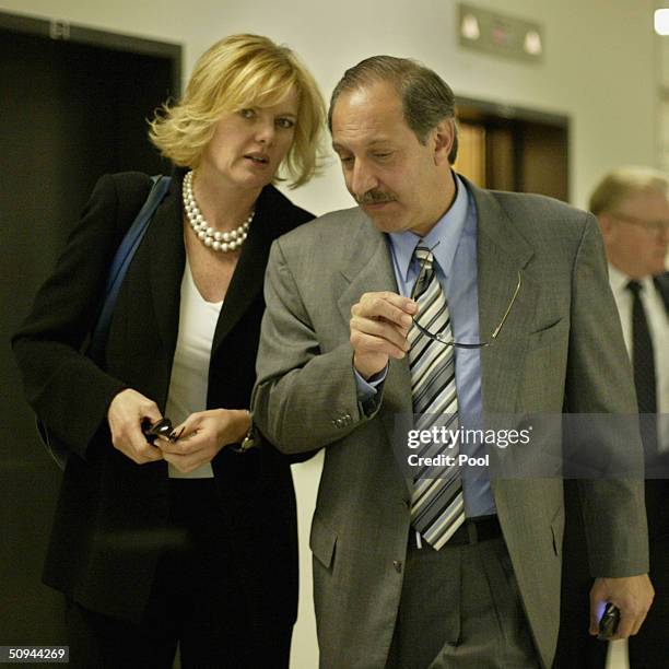 Carol Welsman talks with Scott Peterson's attorney Mark Geragos as they leave the San Mateo County courthouse in Redwood City, California on...