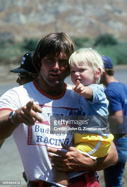 Portrait of media personality and Olympic Decathlon gold medalist Bruce Jenner holding his son Burt at a go-kart race during photo shoot. Malibu, CA...