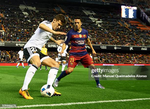 Santi Mina of Valencia competes for the ball with Adriano of Barcelona during the Copa del Rey Semi Final, second leg match between Valencia CF and...