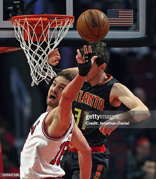 Pau Gasol of the Chicago Bulls reaches for a rebound in front of Mike Muscala of the Atlanta Hawks at the United Center on February 10, 2016 in...