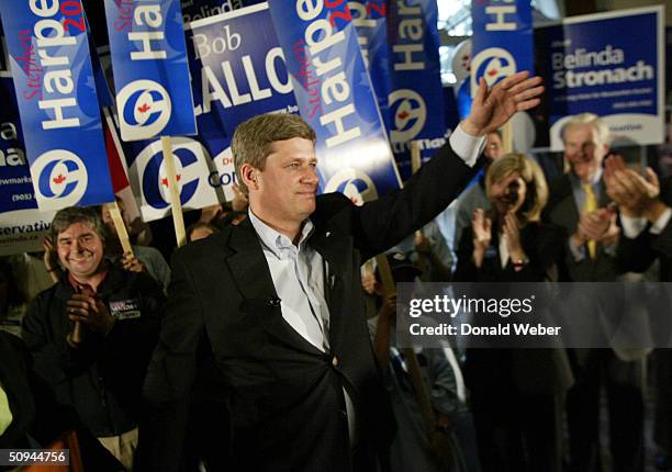 Conservative leader Stephen Harper waves to supporters during an all-candidates rally after delivering a speech June 9, 2004 in Aurora, Canada....