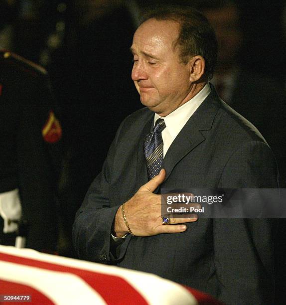 Michael Reagan, son of former U.S. President Ronald Reagan, pauses at his father's casket in the Capitol Rotunda during a state funeral on Capitol...