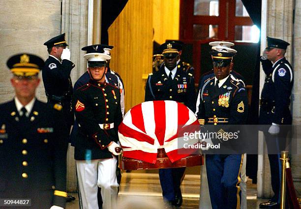 Military honor guard carries the remains of former U.S. President Ronald Reagan during his state funeral on Capitol Hill June 9, 2004 in Washington,...