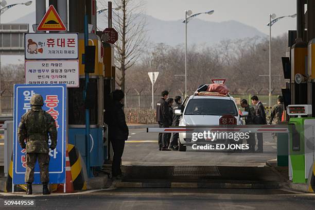 Vehicle leaving the Kaesong joint industrial zone passes through a checkpoint at the CIQ immigration centre near the Demilitarized Zone separating...