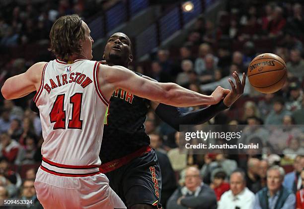 Cameron Bairstow of the Chicago Bulls knocks the ball away from Paul Millsap of the Atlanta Hawks at the United Center on February 10, 2016 in...