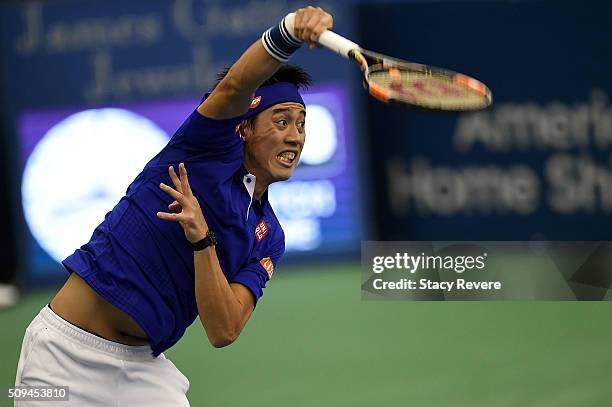 Kei Nishikori of Japan serves to Ryan Harrison of the United States during their singles match on Day 3 of the Memphis Open at the Racquet Club of...