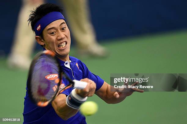 Kei Nishikori of Japan returns a shot from Ryan Harrison of the United States during their singles match on Day 3 of the Memphis Openat the Racquet...