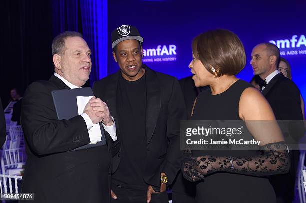 Harvey Weinstein, Jay Z and Grace Hightower attend the 2016 amfAR New York Gala at Cipriani Wall Street on February 10, 2016 in New York City.